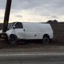 Woman Using Phone Behind The Wheel Totals Van